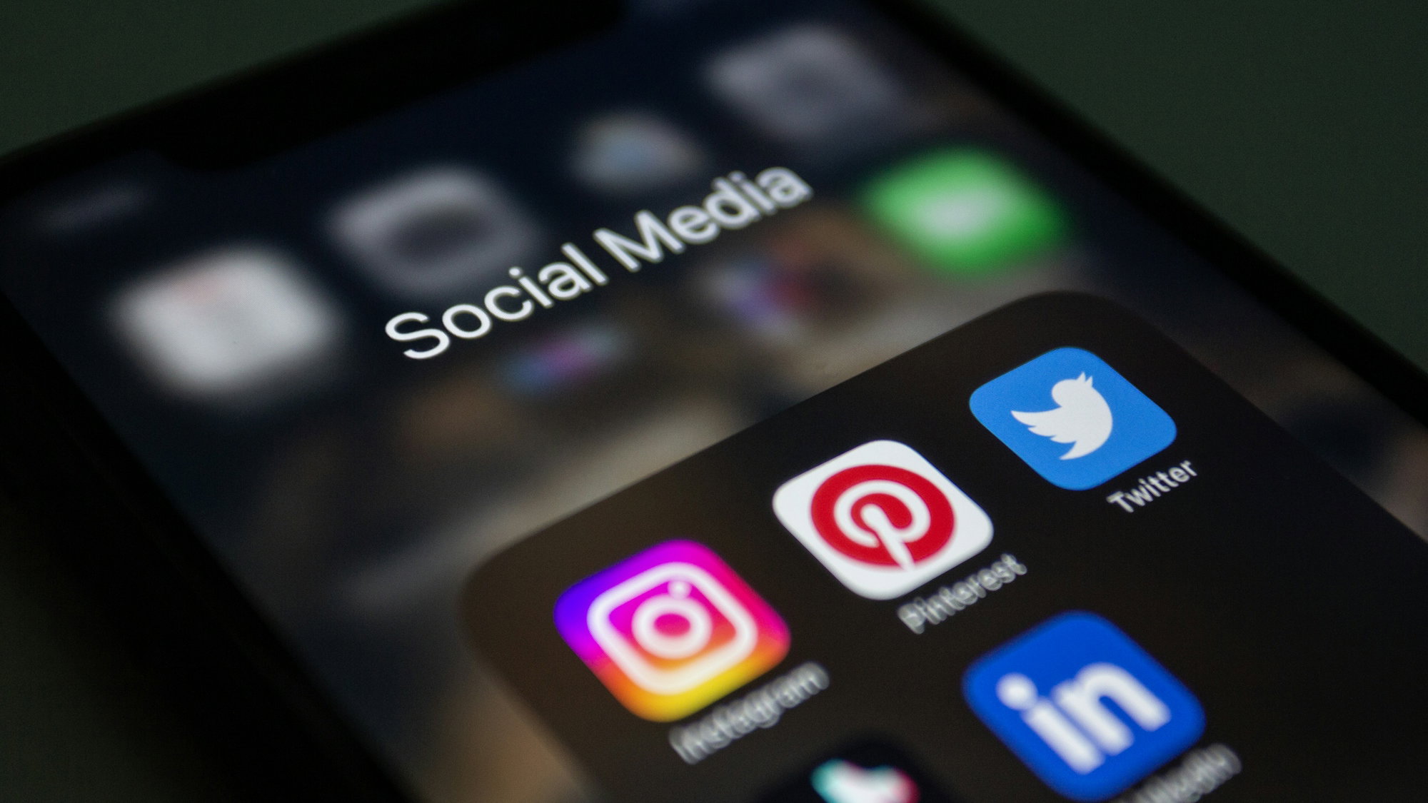 a-close-up-of-a-cell-phone-with-social-media-icons-on-it.jpg a close up of a cell phone with social media icons on it